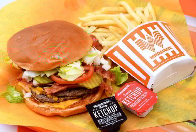 A double meat Whataburger with cheese and bacon, with a side of fries.