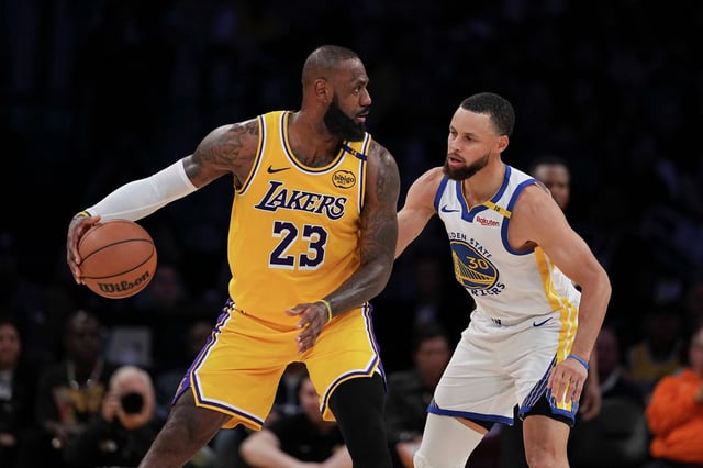 LeBron James of the Los Angeles Lakers controls the ball against Stephen Curry of the Golden State Warriors during the second half of a game at Crypto.com Arena in Los Angeles on April 3, 2025. 
