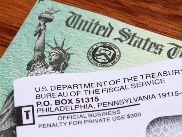 An opened envelope with the return address showing the U.S. Department of the Treasury lies on top of a An opened envelope with the return address showing the U.S. Department of the Treasury lies on top of a United States government Treasury Check. The distinctive green checks feature an engraving of the Statue of Liberty and the Treasury Seal. The government checks are used to disburse income tax refunds as well as Social Security and Medicare benefits.. The distinctive green checks feature an engraving of the Statue of Liberty and the Treasury Seal. The government checks are used to disburse income tax refunds as well as Social Security and Medicare benefits.