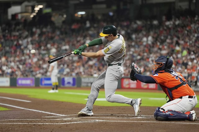 Athletics&#39; Tyler Soderstrom, left, hits a two-run double as Houston Astros catcher Yainer Diaz reaches for the pitch during the first inning of a baseball game Friday, July 25, 2025, in Houston. (AP Photo/David J. Phillip)