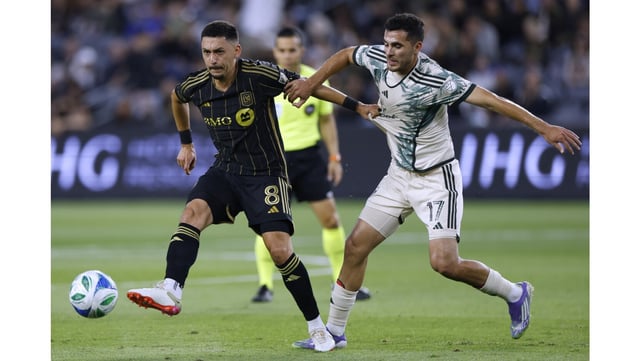 LAFC’s Marco Delgado, left, passes the ball as the Portland Timbers’ Cristhian Paredes defends during their MLS match on Friday night at BMO Stadium. Portland won, 1-0, on a goal by Paredes. (Photo by Harry How/Getty Images)