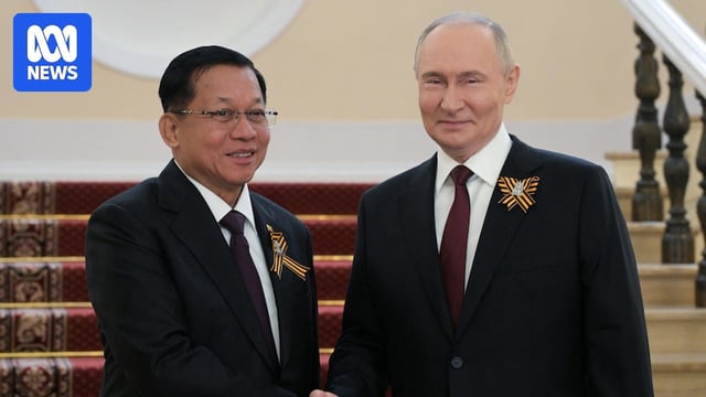 Two men shake hands.