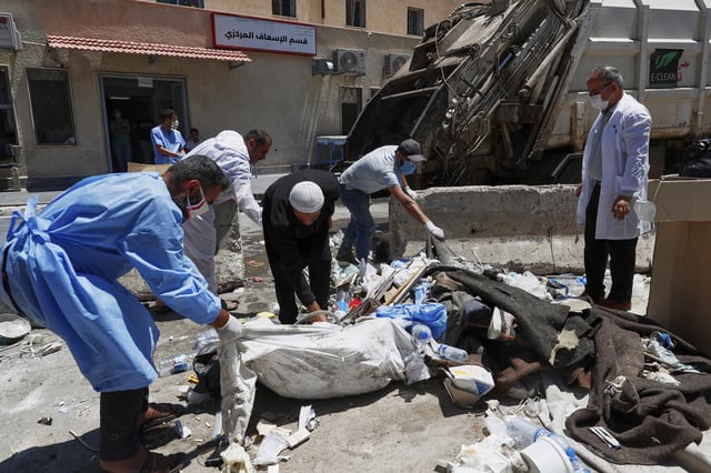 Workers clean the National Hospital following last week's sectarian clashes in the Druze-majority town of Sweida, Syria, on Friday, July 25, 2025. (AP Photo/Omar Sanadiki)