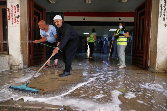 Workers clean a part of the National Hospital after last week's sectarian clashes in the Druze-majority town of Sweida, Syria, on Friday, July 25, 2025. (AP Photo/Omar Sanadiki)