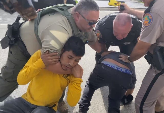Law enforcement officers, including Florida Highway Patrol troopers, were seen in cellphone video recorded by Kenny Laynez-Ambrosio on May 2, 2025, forcefully removing two men from a truck in Palm Beach County after a traffic stop. (Guatemalan-Maya Center/Courtesy)