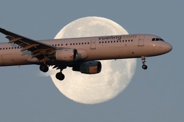 FILE - A Vueling Airbus A321 approaches for landing in Lisbon at sunrise, while the moon sets in the background,, Feb. 7, 2023. (AP Photo/Armando Franca, File)