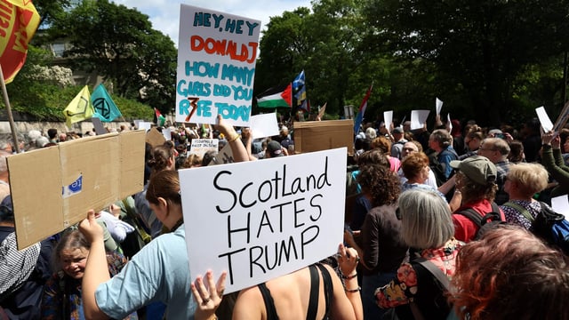 Demonstrators hold placards reading ‘Scotland hates Trump’ near the US Consulate building in Edinburgh, Scotland on July 26, 2025. 