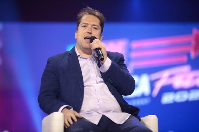 Darren Beattie speaking with attendees at the 2022 AmericaFest at the Phoenix Convention Center in Phoenix, Arizona, on December 19, 2022.