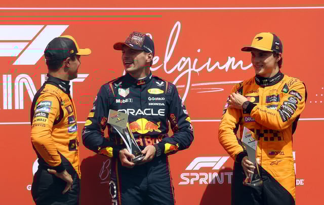 Formula One F1 - Belgian Grand Prix - Circuit de Spa-Francorchamps, Stavelot, Belgium - July 26, 2025 Red Bull's Max Verstappen poses with a trophy after winning the sprint race alongside second place McLaren's Oscar Piastri and third place McLaren's Lando Norris REUTERS/Yves Herman