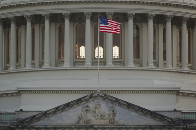 An American flag waves at the U.S. Capitol Building as the sun sets on June 10, 2025 in Washington, DC.