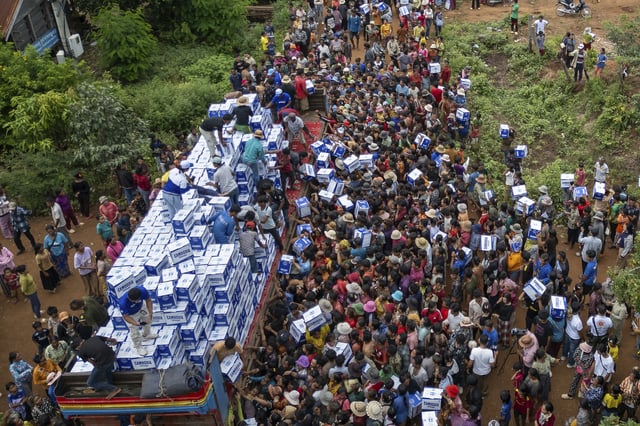 Displaced Cambodians receive water at the Battkhao Resettlement Camp as border clashes between Thailand and Cambodia entered its third day. Oddar Meanchey Province, Cambodia, Saturday, July 26, 2025.