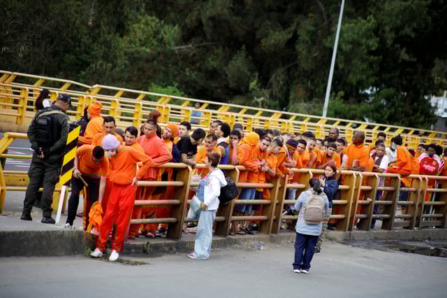 Colombians who are deported by the Ecuadorian government line up at the Rumichaca International Bridge in Colombia, July 26, 2025. Colombian Foreign Ministry/Handout via REUTERS