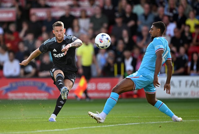 Ross Barkley of Aston Villa shoots past Brandon Comley of Walsall during the pre-season friendly match between Walsall and Aston Villa at Pallet-Track Bescot Stadium on July 16, 2025 in Walsall, England.