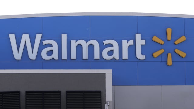 A Walmart logo is displayed outside of a Walmart store, in Walpole, Mass., Sept. 3, 2019.