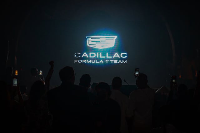 People attend an event to unveil the colors for the 2026 Cadillac debut in Formula One racing, ahead of the 2025 Miami Formula One Grand Prix, in Miami Beach, Florida, on May 3, 2025.