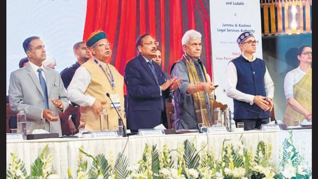 Justice Surya Kant, J&K Lt Guv Manoj Sinha, J&K CM Omar Abdullah and Union law minister Arjun Ram Meghwal during the launch of Veer Parivar Sahayata Yojana in Srinagar. (HT Photor)