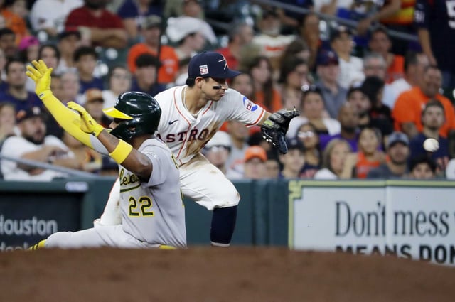 AthleticsÕ Miguel Andujar (22) is safe at third base as Houston Astros third baseman Mauricio Dubon, right, gets the throw late during the fouth inning of a baseball game Saturday, July 26, 2025, in Houston.