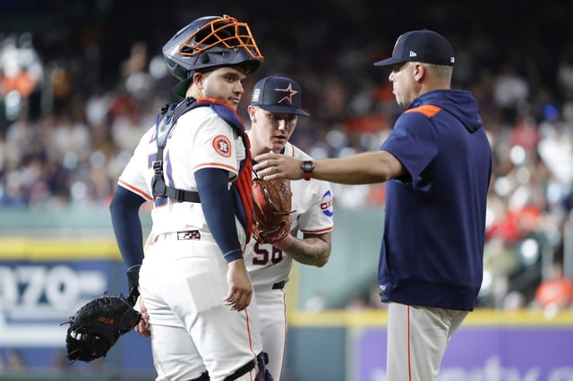 Houston Astros catcher Yainer Diaz, left, starting pitcher Hunter Brown, center, and pitching coach Josua Miller, right, meet at the mound during the  inning of a baseball game against the Athletics Saturday, July 26, 2025, in Houston.