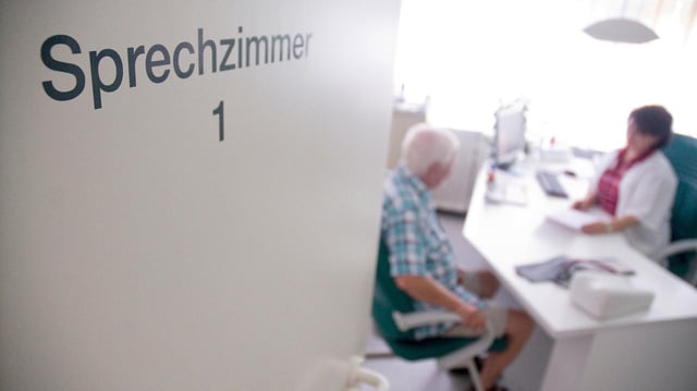 In der Tür einer Hausarztpraxis ist der Schriftzug "Sprechzimmer" zu sehen.