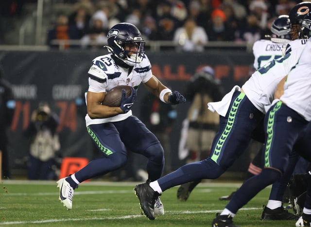 Dec 26, 2024; Chicago, Illinois, USA; Seattle Seahawks running back Kenny McIntosh (25) runs for a gain during the first quarter against the Chicago Bears at Soldier Field. Mandatory Credit: Talia Sprague-Imagn Images/File Photo
