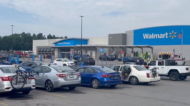 Emergency personnel stand outside a Walmart store, where a stabbing incident occurred, in Traverse City, Michigan, on Saturday.