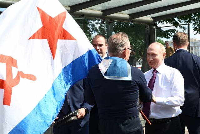 Russian President Vladimir Putin greets a man, who celebrates Russia's Navy Day in Saint Petersburg, Russia, July 27, 2025. Sputnik/Alexei Danichev/Pool via REUTERS