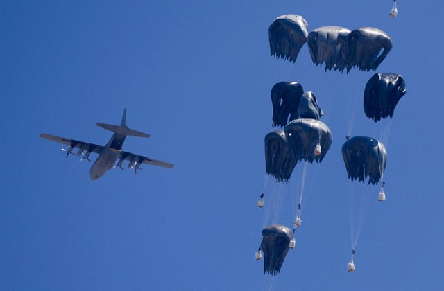 An airplane drops humanitarian aid over Gaza as seen from northern Gaza Strip on Sunday.
