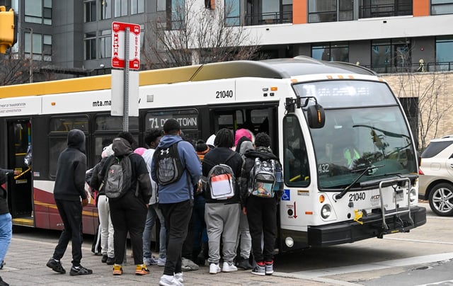 Digital Harbor High School students travel on a public bus along Key Highway, heading toward Cherry Hill. (Kevin Richardson/Staff)