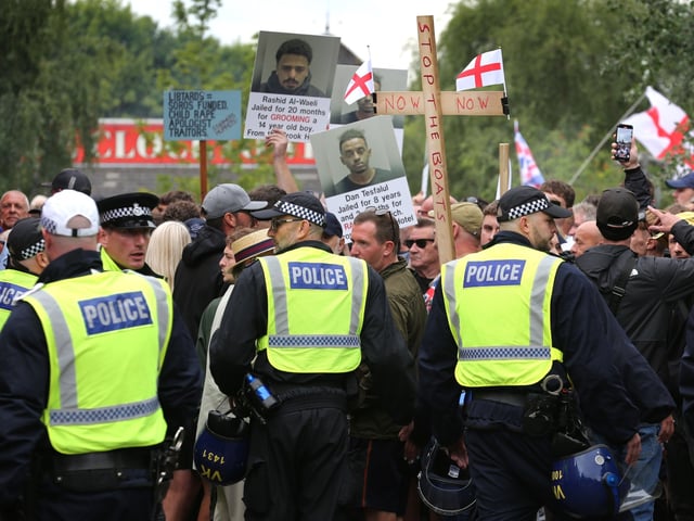 NORWICH, ENGLAND - JULY 26: Protesters against the asylum seekers being housed in the Brook Hotel come up against a police cordon, set up between protest groups to keep them apart during the demonstration on July 26, 2025 in Norwich, United Kingdom. Protesters gathered outside the Brook Hotel to demonstrate against asylum seekers who are being housed inside. There have been a series of protests across England in recent weeks outside hotels that are being used (or planning to be used) by the Home Office to house asylum seekers. (Photo by Martin Pope/Getty Images)