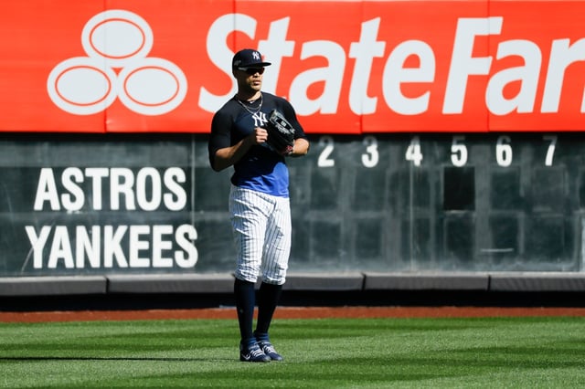 New York Yankees left fielder Giancarlo Stanton waits for balls in the outfield during batting practice before Game 3 of baseball&#39;s American League Championship Series against the Houston Astros, Tuesday, Oct. 15, 2019, in New York. (AP Photo/Matt Slocum)