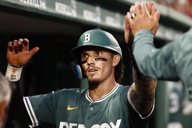 BOSTON, MA - JULY 25: Jarren Duran #16 of the Boston Red Sox is congratulated in the dugout after scoring against the Los Angeles Dodgers during the third inning at Fenway Park on July 25, 2025 in Boston, Massachusetts.