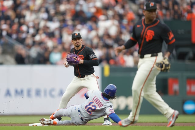 Willy Adames #2 of the San Francisco Giants gets the out at second base of Francisco Lindor #12 of the New York Mets in the top of the first inning at Oracle Park on July 26, 2025 in San Francisco, California.