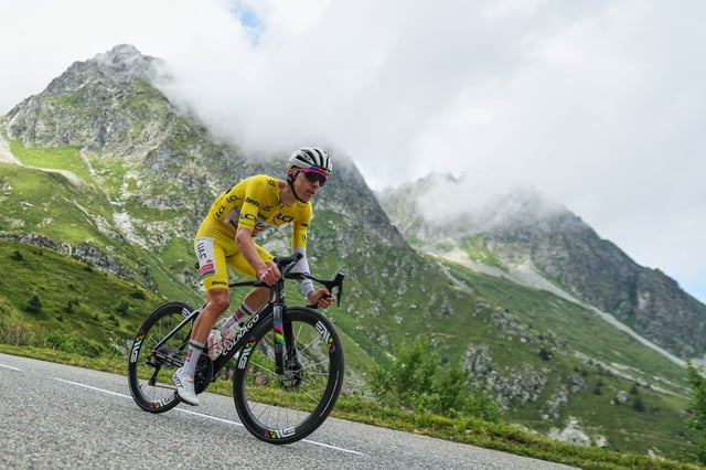 Slovenia's Tadej Pogačar, wearing the overall leader's yellow jersey, speeds down Col de la Madeleine during the 18th stage of the Tour de France on Thursday.