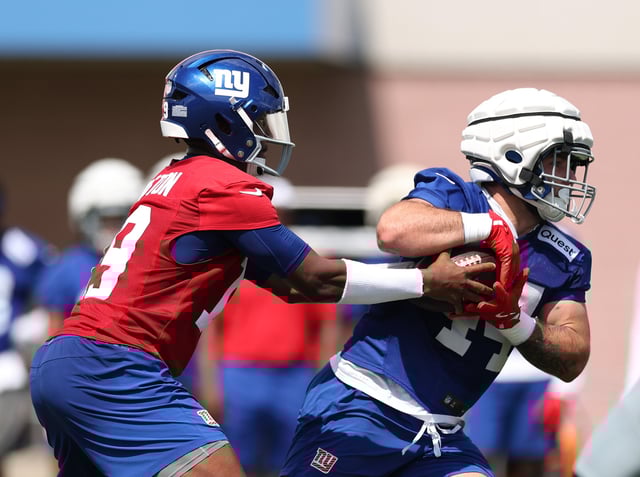 Jameis Winston #19 hands the ball to Cam Skattebo #44 of the New York Giants during training camp at Quest Diagnostics Training Center on July 23, 2025 in East Rutherford, New Jersey.