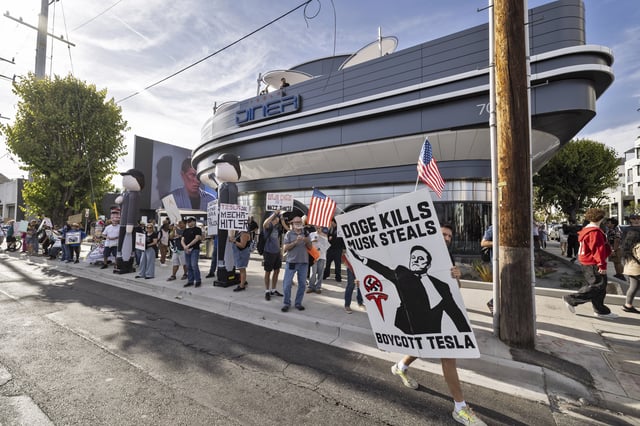 Anti-Tesla and Elon Musk protesters demonstrated out front of the new Tesla Diner and Super Charger venue in Los Angeles, on July 26, 2025.