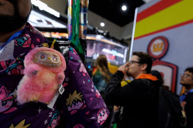An attendee wears a Labubu at the Pop Mart booth on the convention floor during the opening day of Comic-Con International in San Diego, California, U.S. July 24, 2025.   REUTERS/Mike Blake/File Photo