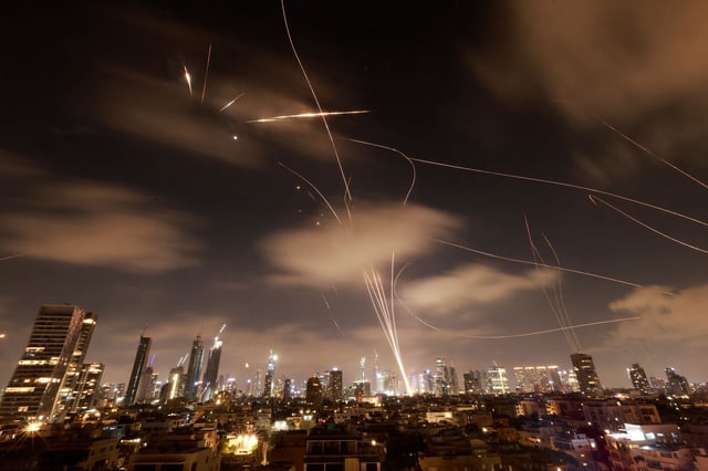Israeli air defence systems are activated to intercept Iranian missiles over the Israeli city of Tel Aviv early on June 18, 2025. Israel and Iran exchanged fire again on June 17, the fifth day of strikes in their most intense confrontation in history, fuelling fears of a drawn-out conflict that could engulf the Middle East.