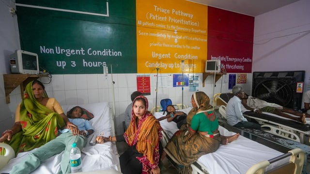 Barabanki: Family members sit beside injured people undergoing treatment at a hospital following a stampede at Avsaneshwar temple.