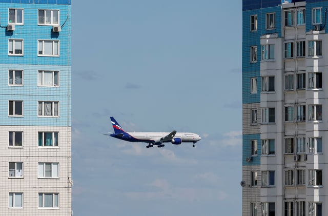 An Aeroflot passenger aircraft flies past multi-storey apartment blocks before landing at Sheremetyevo International Airport, on the outskirts of Moscow, Russia July 24, 2024. REUTERS/Shamil Zhumatov/File Photo