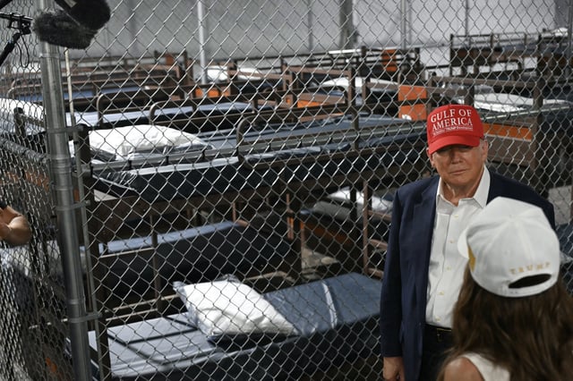 President Donald Trump speaks with Secretary of Homeland Security Kristi Noem as they tour a migrant detention center, dubbed Alligator Alcatraz, located at the site of the Dade-Collier Training and Transition Airport in Ochopee, Fla. on July 1, 2025.
