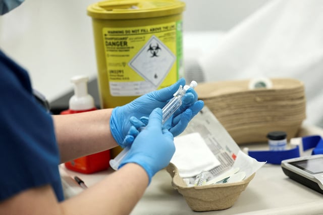 A Nuclear Medicine technologist prepares to give a tracer injection to a cancer patient at the Nuclear Medicine department of University College London Hospitals (UCLH), in London, Britain, January 29, 2025. REUTERS/Isabel Infantes/File Photo