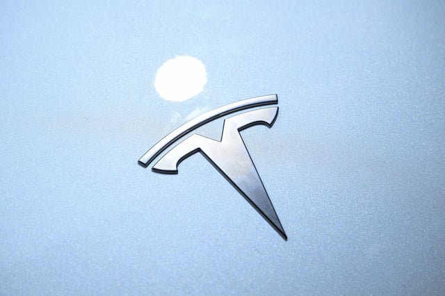 The Tesla logo is seen on a car at the company's stand during the World Artificial Intelligence Conference (WAIC) at the Shanghai World Expo and Convention Center in Shanghai on July 28, 2025. (Photo by Hector RETAMAL / AFP) (Photo by HECTOR RETAMAL/AFP via Getty Images)