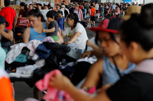 Residents pick up free groceries and clothes at La Colaborativa's food pantry in Chelsea, Massachusetts, U.S., July 1, 2025. REUTERS/Brian Snyder/File Photo