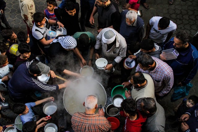 A group of people wait to be served food, Gaza, Palestine. Credit: ZUMA Press, Inc. / Alamy Stock Photo