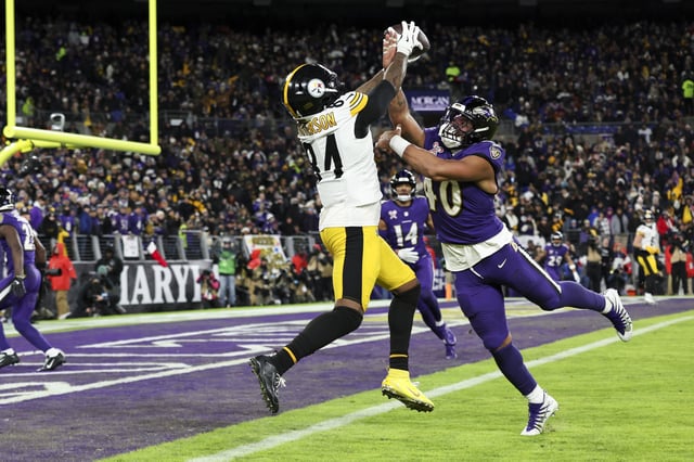 BALTIMORE, MARYLAND - DECEMBER 21: Cordarrelle Patterson #84 of the Pittsburgh Steelers makes a catch for a touchdown as Malik Harrison #40 of the Baltimore Ravens defends during a game at M&amp;T Bank Stadium on December 21, 2024 in Baltimore, Maryland.