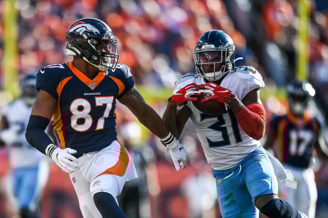 Kevin Byard #31 of the Tennessee Titans intercepts a pass intended for Noah Fant #87 of the Denver Broncos in the third quarter of a game at Empower Field at Mile High on October 13, 2019 in Denver, Colorado.