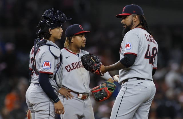 Emmanuel Clase #48 of the Cleveland Guardians is visited on the mound by catcher Bo Naylor #23 and third baseman José Ramírez #11 during the 10th inning of a game against the Detroit Tigers at Comerica Park on May 24, 2025 in Detroit, Michigan.
