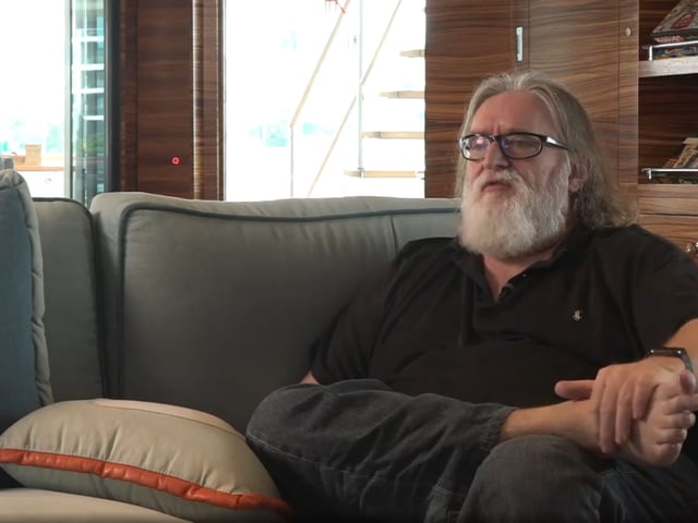 Gabe Newell sat on a sofa, barefoot, talking about brain-computer interface technology