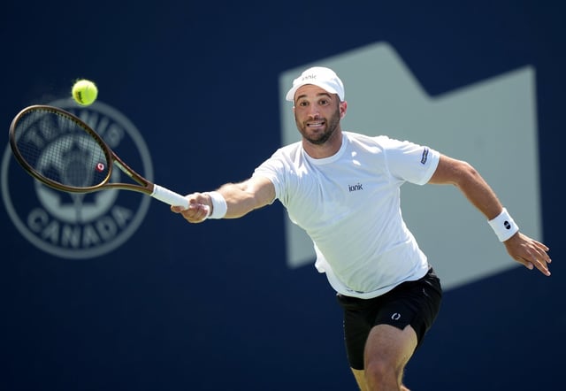 Dan Martin of Canada returns the ball against Jaume Munar of Spain during first-round tennis action at the National Bank Open  in Toronto on Monday, July 28, 2025.  THE CANADIAN PRESS/Nathan Denette
