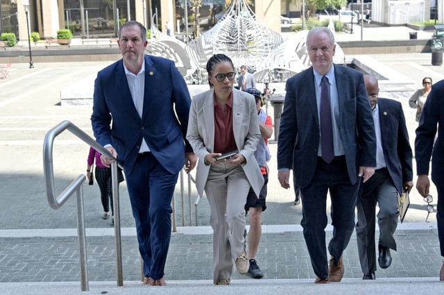 From left, U.S. Representative Johnny Olszewski, Jr. (MD-02), U.S. Senators Angela Alsobrooks and Chris Van Hollen (D-MD) climb the stairs to the George H. Fallon Federal Building to conduct an official oversight visit of the U.S. Immigration and Customs Enforcement (ICE) holding facility. They were denied access to the holding facility. (Kim Hairston/Staff)